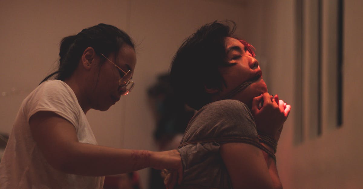 Traveling back from Bangladesh [closed] - Ethnic woman performing ancient rite win young tied man indoors