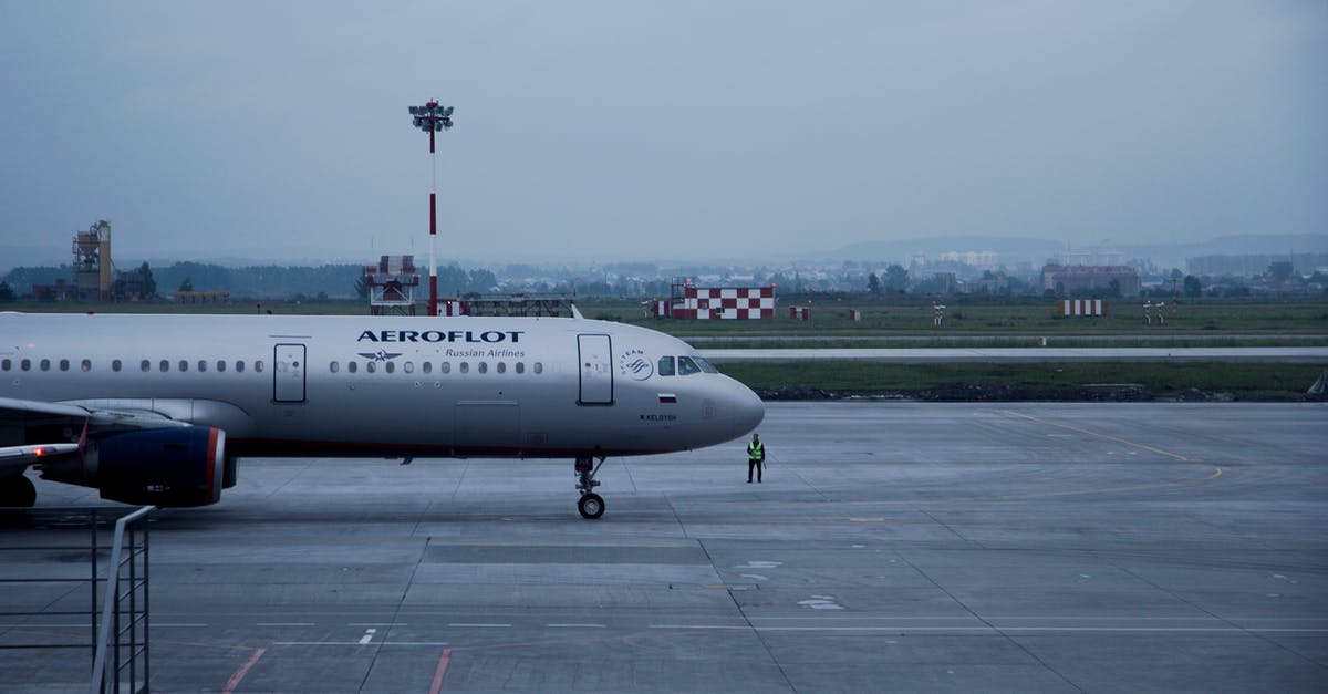Traveling by Air with a Large "Husky" Mobile Job Box - White Aeroflot Passenger Plane on Airport Traveling by Air with a Large "Husky" Mobile Job Box - White Aeroflot Passenger Plane on Airport