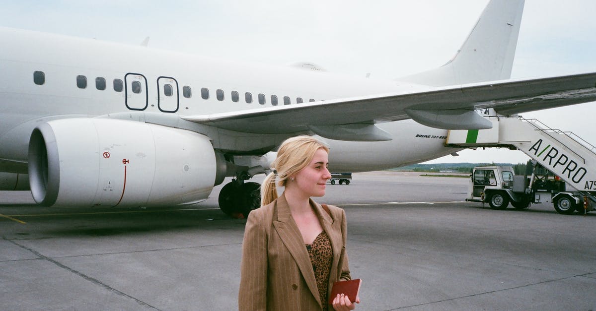 Traveling by plane within Mexico without a passport - Smiling tourist with passport near airplane on road Traveling by plane within Mexico without a passport - Smiling tourist with passport near airplane on road