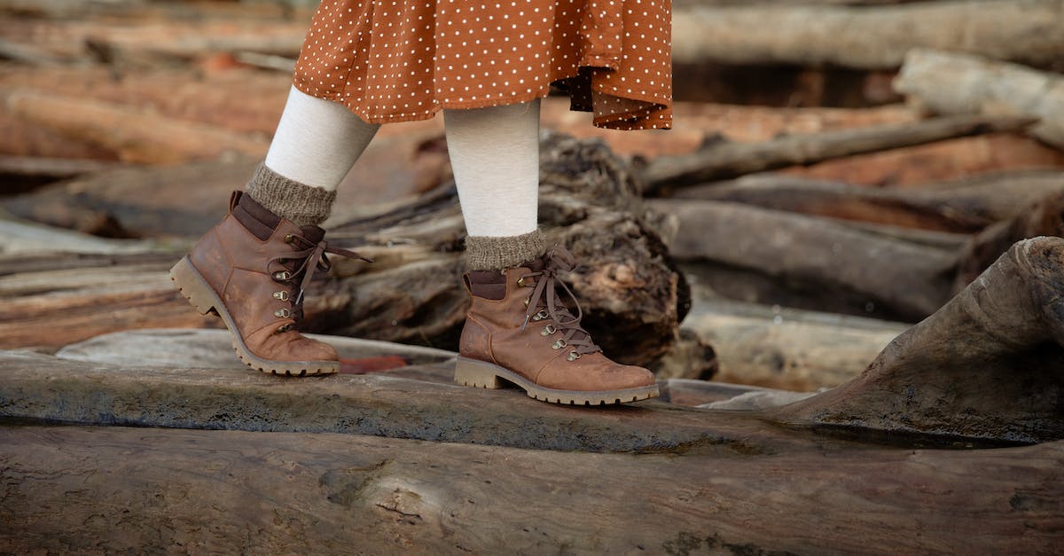 Traveling from cold region to warm region; tips regarding clothing? - Unrecognizable crop woman wearing warm casual boots and skirt walking on log while spending time in countryside during weekend trip in autumn Traveling from cold region to warm region; tips regarding clothing? - Unrecognizable crop woman wearing warm casual boots and skirt walking on log while spending time in countryside during weekend trip in autumn