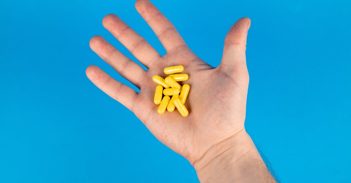 Traveling from Europe to Beijing, China with prescription drugs - Person Holding Yellow Plastic Beads Traveling from Europe to Beijing, China with prescription drugs - Person Holding Yellow Plastic Beads