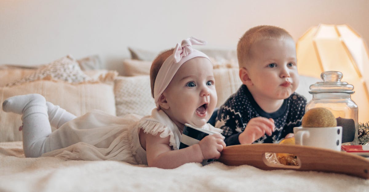 Traveling from heathrow UK with baby food glass jars - Children lying on bed at home and looking away Traveling from heathrow UK with baby food glass jars - Children lying on bed at home and looking away