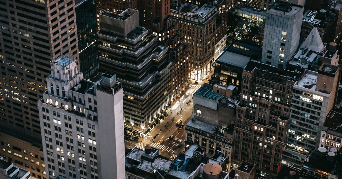Traveling from JFK to Manhattan with 6 bags - Modern illuminated city district in evening Traveling from JFK to Manhattan with 6 bags - Modern illuminated city district in evening