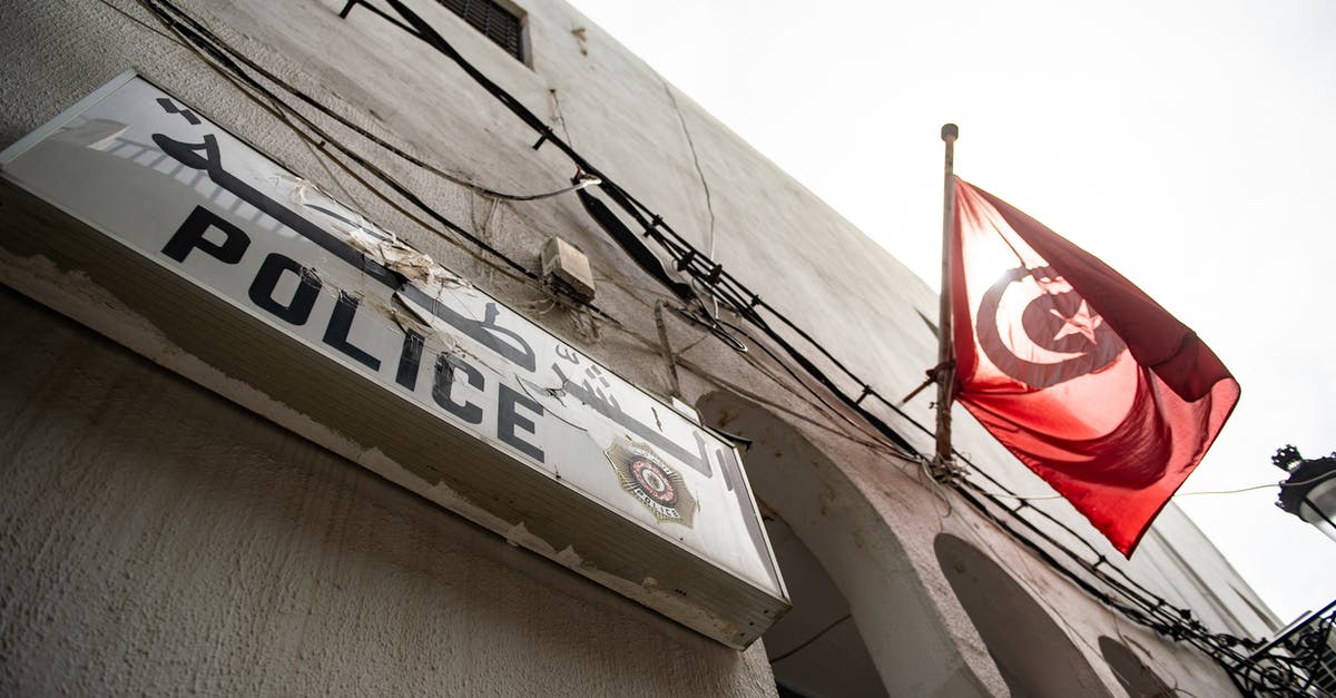 Traveling from LAX to Cape Town with Turkish Airlines - From below exterior of concrete house with arched elements and Police signboard and hanging flag of Turkey located on street in city Traveling from LAX to Cape Town with Turkish Airlines - From below exterior of concrete house with arched elements and Police signboard and hanging flag of Turkey located on street in city