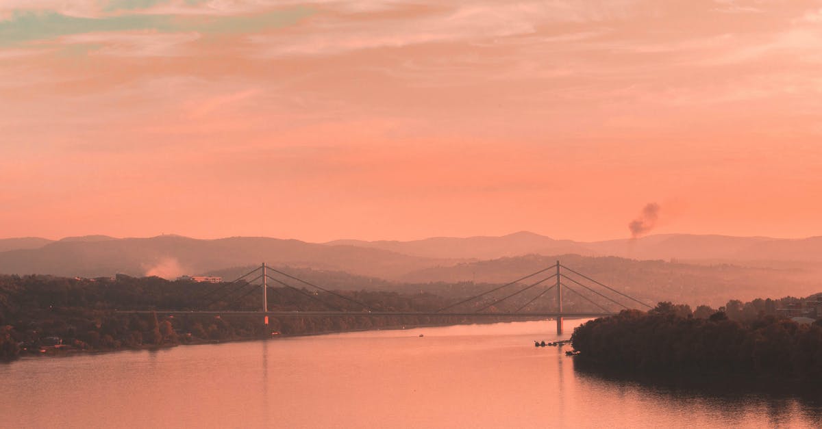Traveling to Serbia - Body of Water Near Mountain during Sunset Traveling to Serbia - Body of Water Near Mountain during Sunset