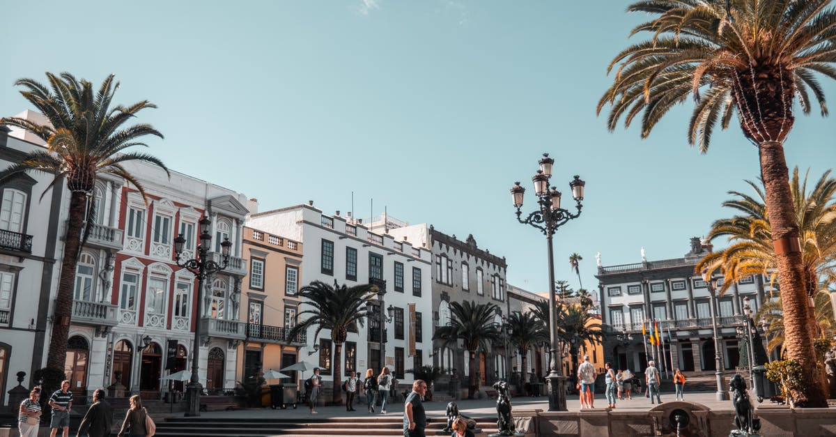 Traveling to Spain as tourist before entering France on type D visa [duplicate] - People Standing and Sitting at the Open Park Near Buildings