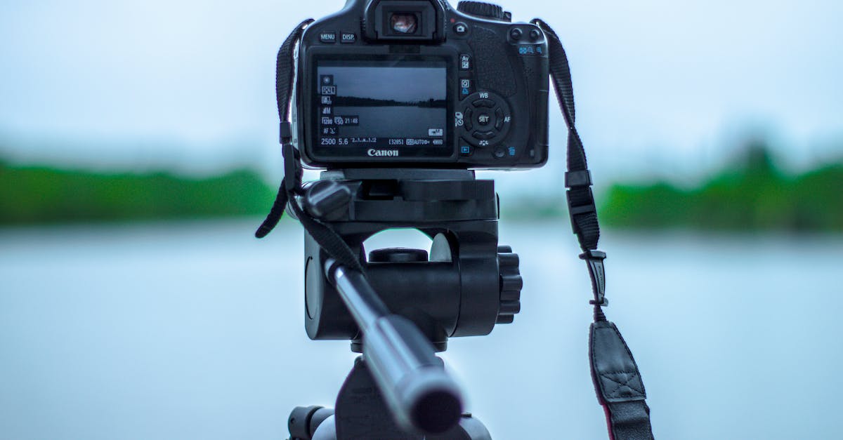 Traveling to USA with tripod attached to my camera bag - Selective Focus Photo of Black Canon Camera on Tripod Stand in Front of Body of Water Photo Traveling to USA with tripod attached to my camera bag - Selective Focus Photo of Black Canon Camera on Tripod Stand in Front of Body of Water Photo