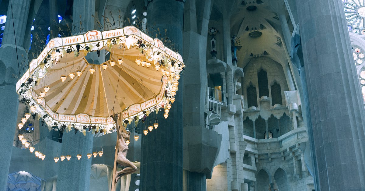 Travelling - Spain from France on 11 Feb - From below pillars and decorative ceiling with ornamental chandelier in Basilica de la Sagrada Familia in Barcelona Travelling - Spain from France on 11 Feb - From below pillars and decorative ceiling with ornamental chandelier in Basilica de la Sagrada Familia in Barcelona