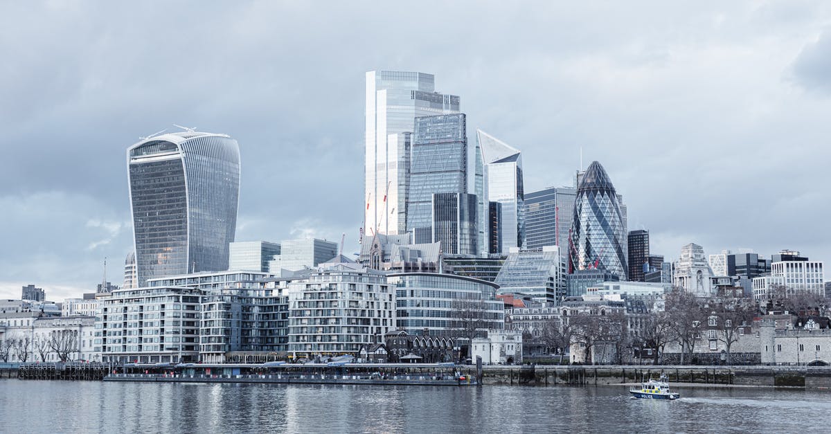 Travelling outside the UK without a passport - Contemporary multistory high rise business centers located on embankment with trees near Thames river in London city Travelling outside the UK without a passport - Contemporary multistory high rise business centers located on embankment with trees near Thames river in London city