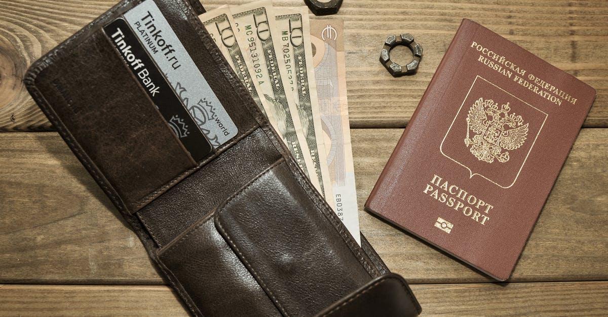 Travelling through Turkey with Russian Passport - Photograph of a Leather Wallet with Dollar Bills Beside a Passport Travelling through Turkey with Russian Passport - Photograph of a Leather Wallet with Dollar Bills Beside a Passport