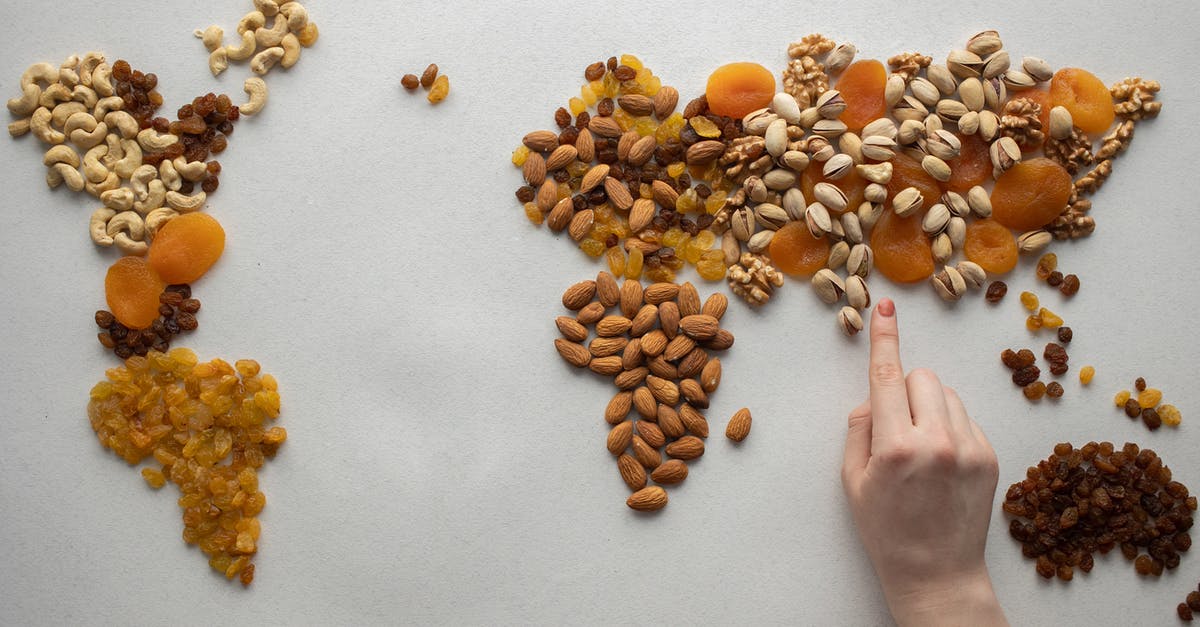 Travelling to Asia and Oceania with a peanut and pistachio allergy - Faceless person making world map with nuts and dried fruits Travelling to Asia and Oceania with a peanut and pistachio allergy - Faceless person making world map with nuts and dried fruits