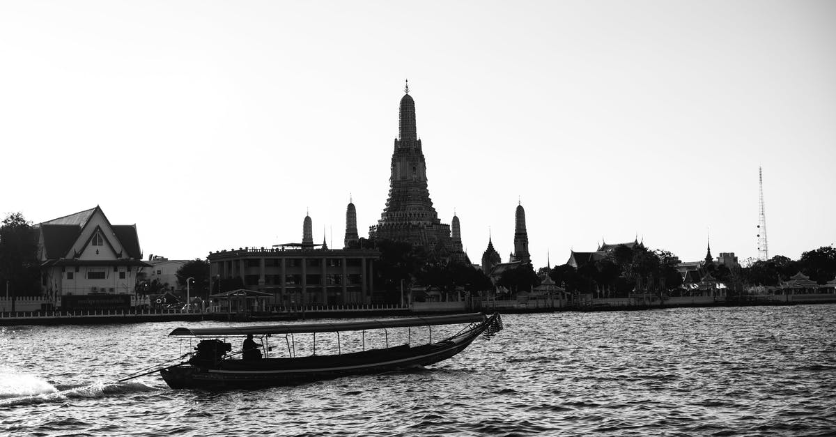 Travelling to Asia and Oceania with a peanut and pistachio allergy - Grayscale Photo of Boat on Water Near Building Travelling to Asia and Oceania with a peanut and pistachio allergy - Grayscale Photo of Boat on Water Near Building