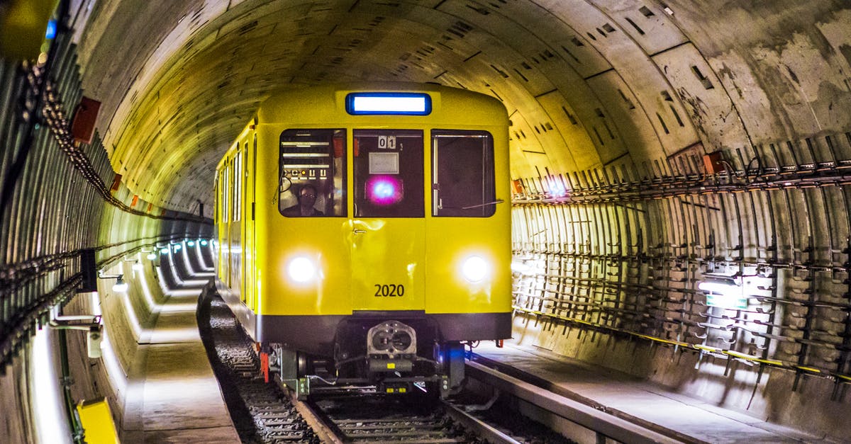 Travelling to Berlin without a bank statement - Yellow and Black Train Under Tunnel Travelling to Berlin without a bank statement - Yellow and Black Train Under Tunnel