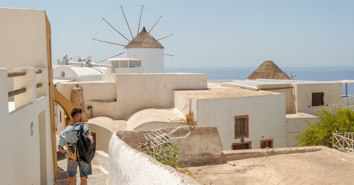 Travelling to Greece without knowing the language - Man in Black Jacket Walking on White Concrete Pathway Travelling to Greece without knowing the language - Man in Black Jacket Walking on White Concrete Pathway