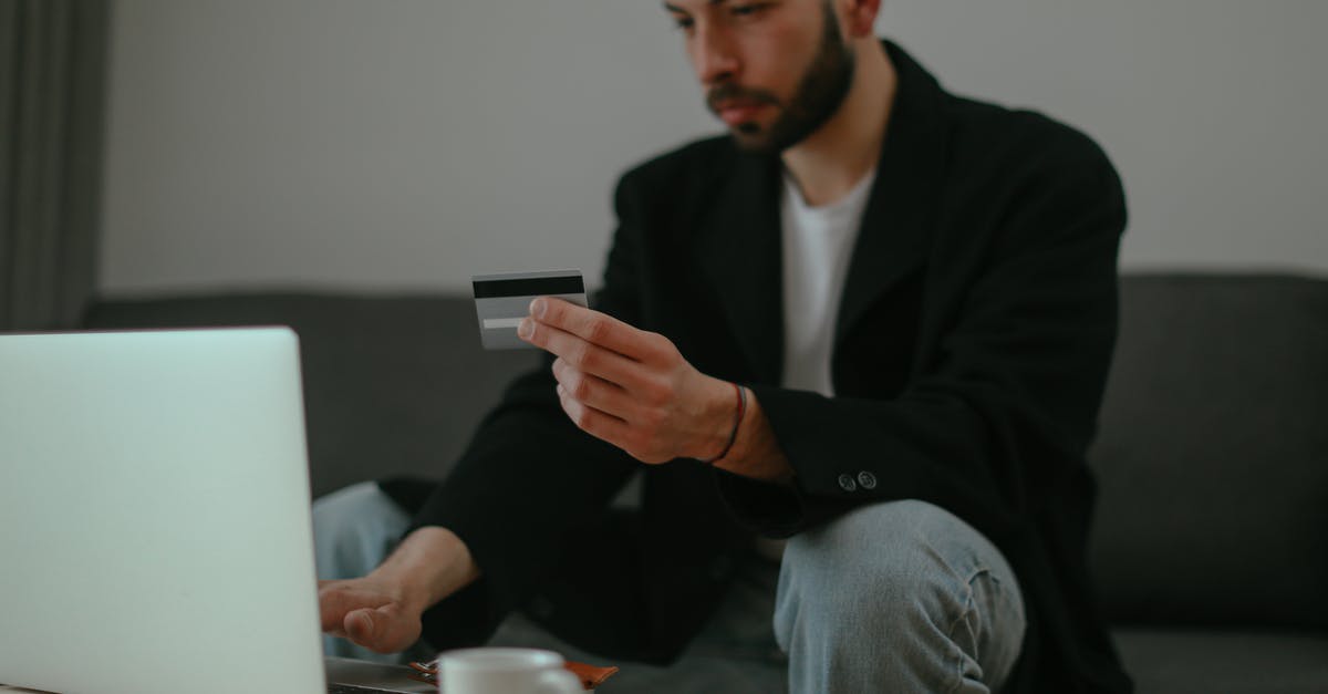 Travelling to Montenegro using a Blue Card - Man in Black Sweater Holding Smartphone Travelling to Montenegro using a Blue Card - Man in Black Sweater Holding Smartphone