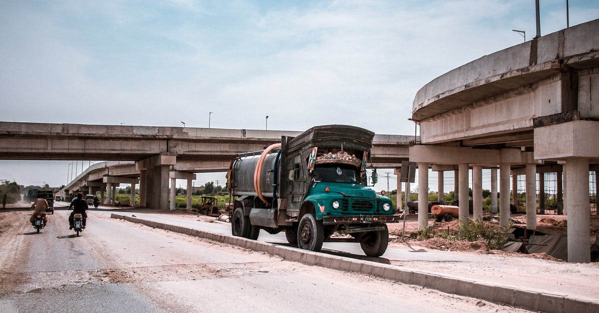 Travelling to Pakistan with expired NICOP - Blue and Black Truck on Road Near Building and Two Motorcycles Travelling to Pakistan with expired NICOP - Blue and Black Truck on Road Near Building and Two Motorcycles
