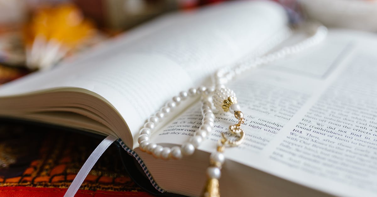 Travelling to the Sacred Well in Walsingham Norfolk (Sacred Spring in England) - Gold and Silver Beaded Necklace on White Book Page Travelling to the Sacred Well in Walsingham Norfolk (Sacred Spring in England) - Gold and Silver Beaded Necklace on White Book Page