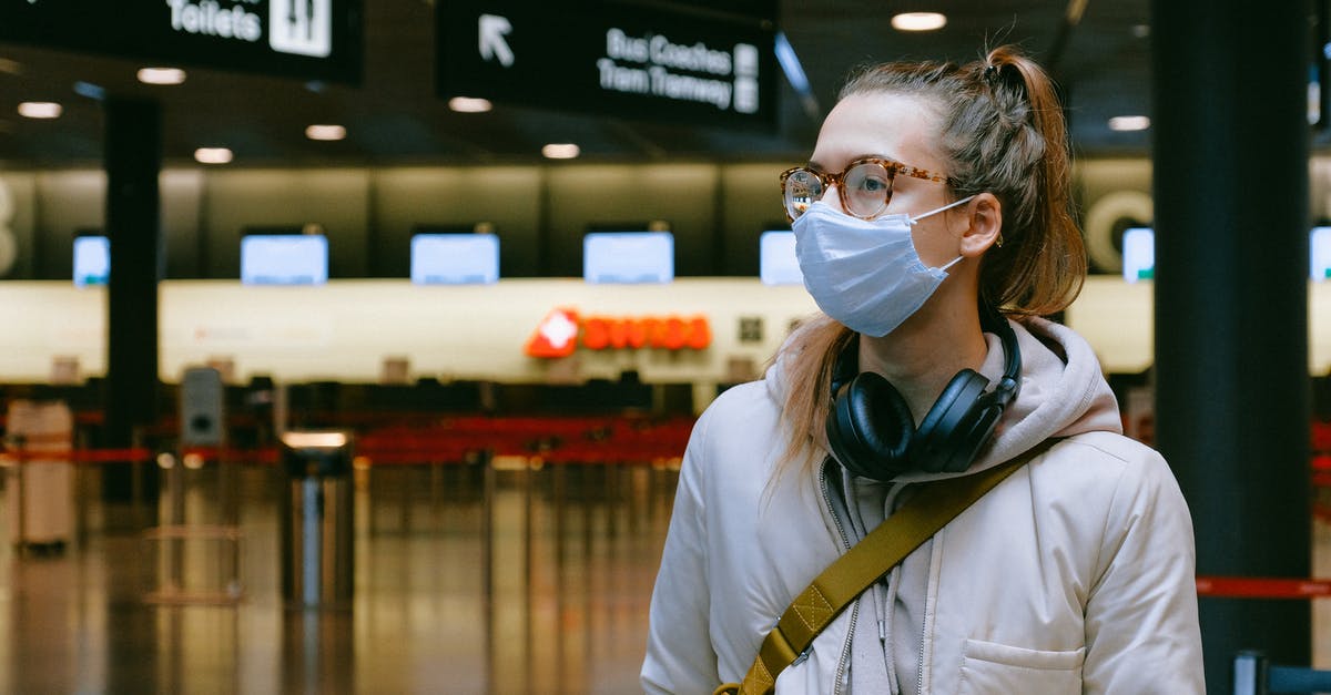 Travelling with 2 passports (different spelling) - Woman Wearing Face Mask Travelling with 2 passports (different spelling) - Woman Wearing Face Mask