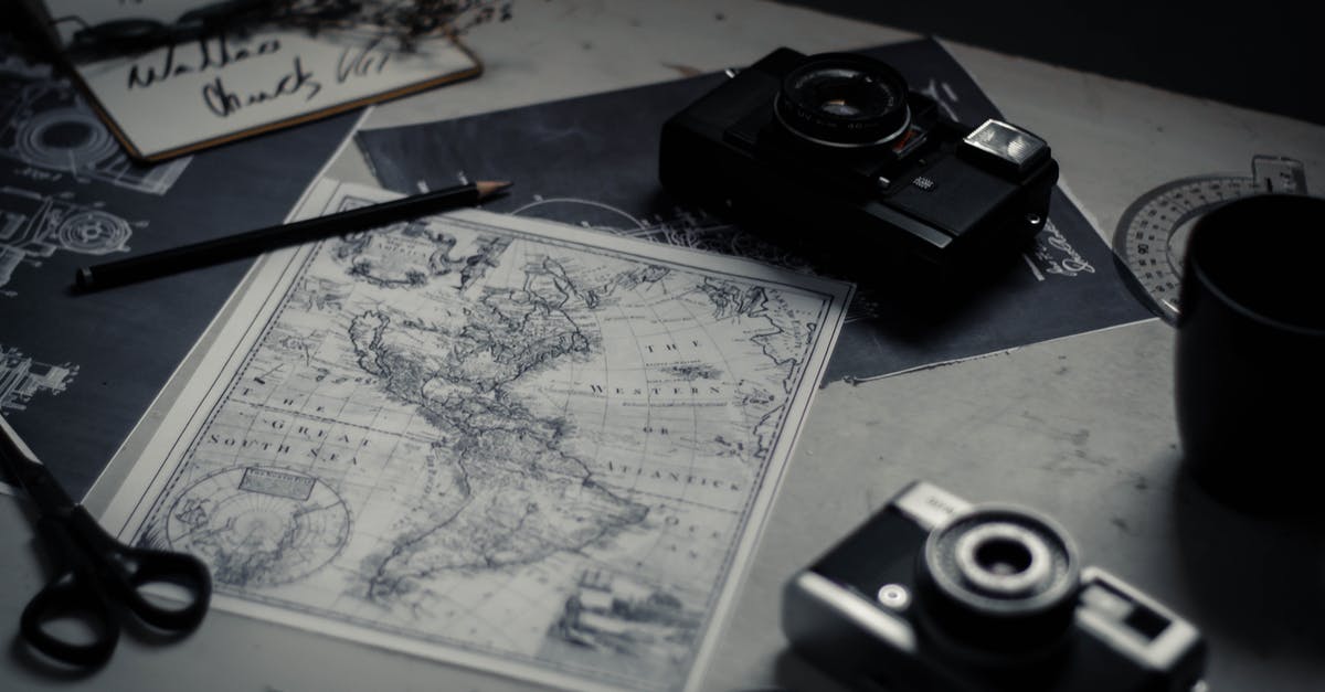 Travelling with research equipment - Electronic devices and paper map on table Travelling with research equipment - Electronic devices and paper map on table