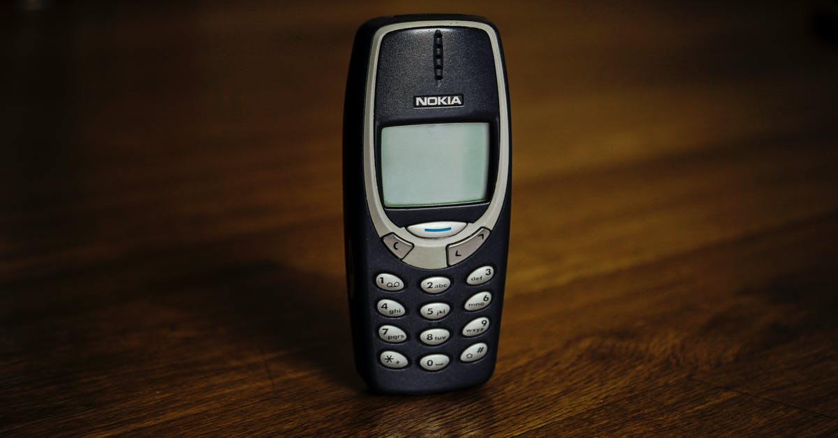 TSA asking to see cell phone - Retro cellphone with buttons placed on table TSA asking to see cell phone - Retro cellphone with buttons placed on table