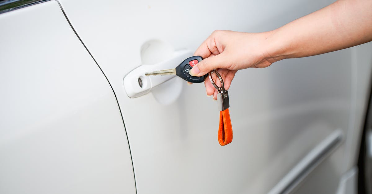 TSA unlock at airport? - A Person Holding a Car Key Near a Car Door TSA unlock at airport? - A Person Holding a Car Key Near a Car Door
