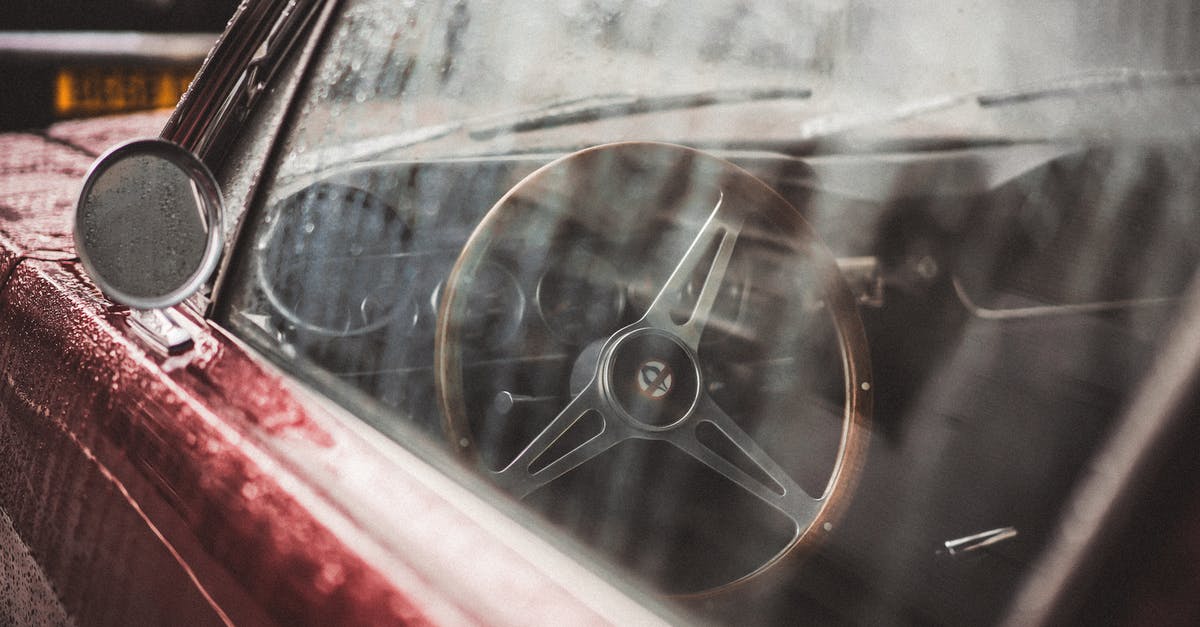 Turn on red with a traffic light at the right side of the street across in California - A Wet Red Classic Car Turn on red with a traffic light at the right side of the street across in California - A Wet Red Classic Car