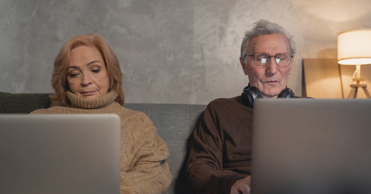 Two adults staying in a room that says "one adult" on the reservation [duplicate] - Elderly Man And Woman Sitting On Couch Using Laptop Computers