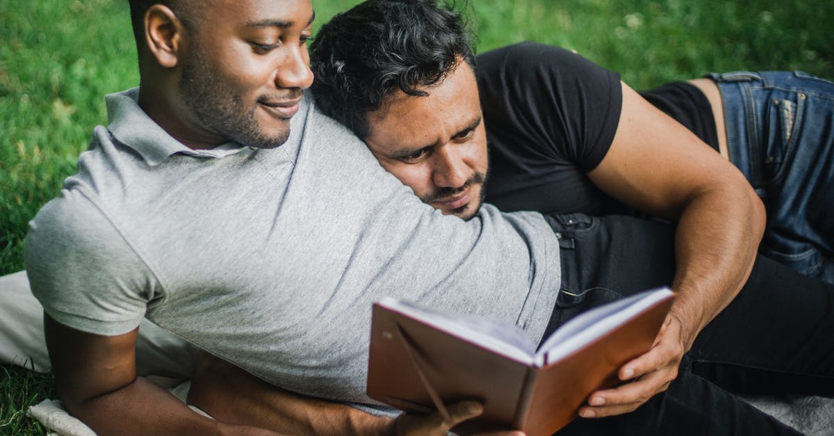 Two passports, two different names, booked a flight - Two Adult Men Lying Together and Reading Book Two passports, two different names, booked a flight - Two Adult Men Lying Together and Reading Book