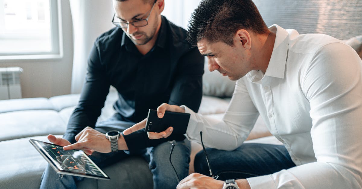 Two separate tickets for connecting flights - Two Men Pointing at iPad Screen
Two separate tickets for connecting flights - Two Men Pointing at iPad Screen