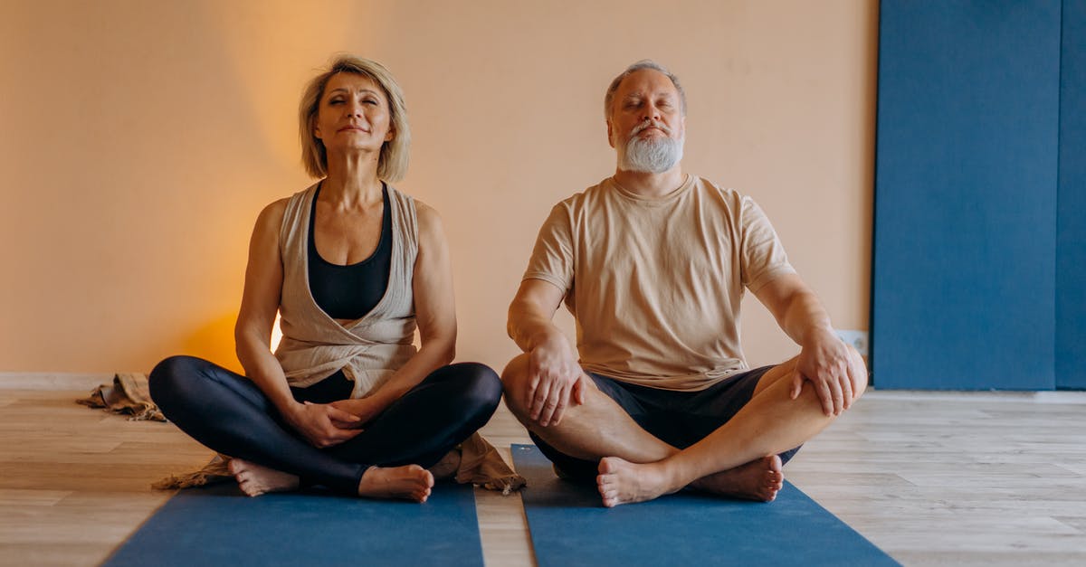 Two Weeks in Cambridge (England), practicing sport in group - Man and Woman Sitting on Blue Yoga Mat Two Weeks in Cambridge (England), practicing sport in group - Man and Woman Sitting on Blue Yoga Mat