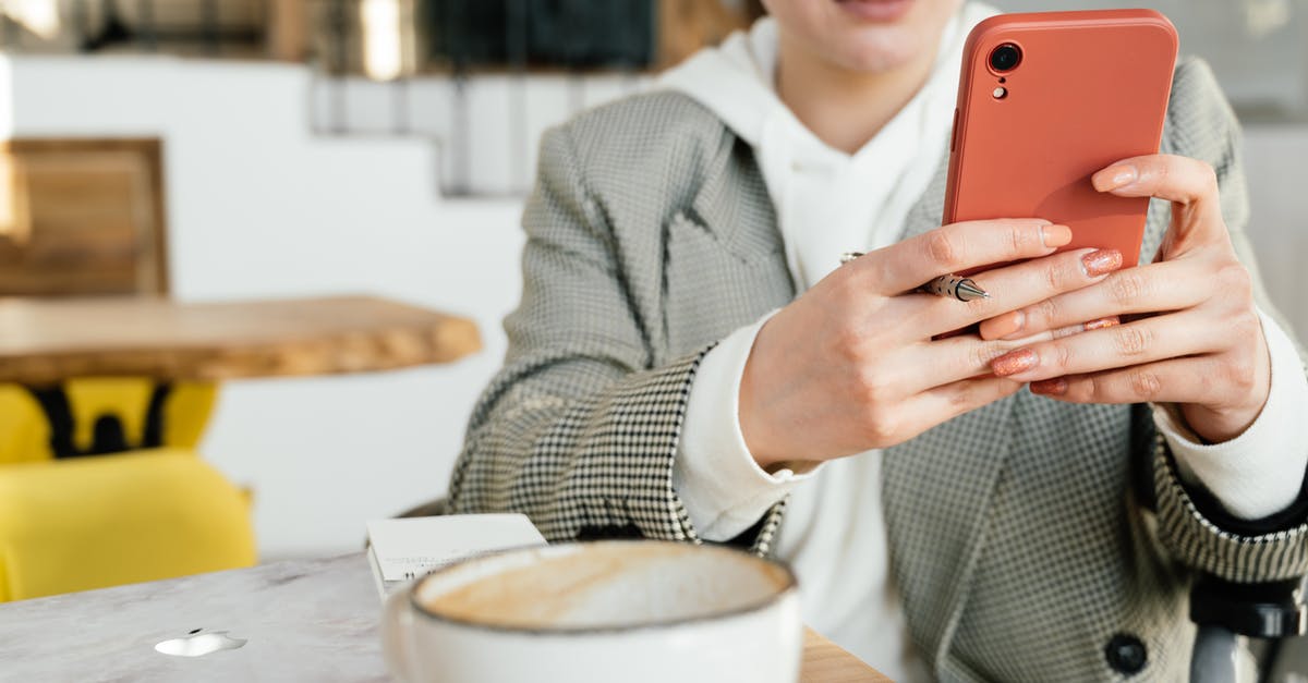 Type of Affidavit to submit for Canada TRV application - Crop focused female in formal wear and eyeglasses browsing mobile phone while having coffee in cafeteria