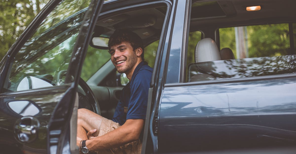 Uber Car Seat/Family Orlando - Man Inside Vehicle in Front of Opened Door Uber Car Seat/Family Orlando - Man Inside Vehicle in Front of Opened Door