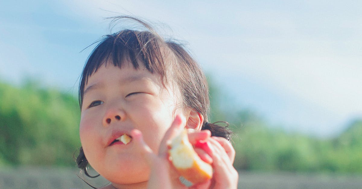 Uganda Child travelling to the UK [closed] - Close-up Photography Of A Girl Eating Bread