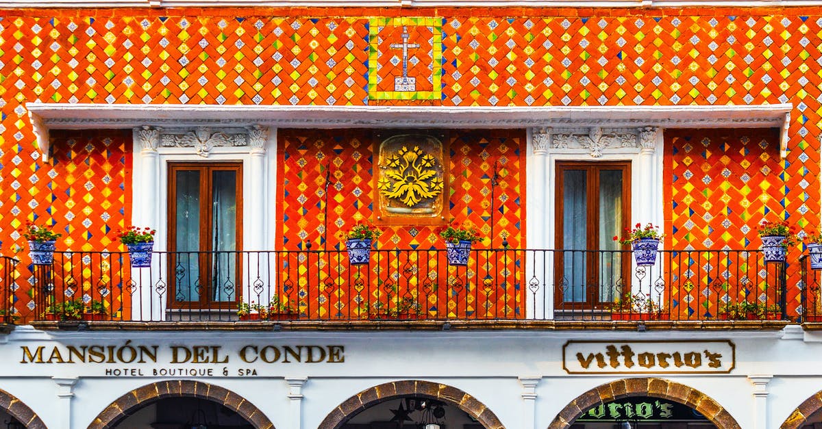 UK - Spousal Visa Travelling to Mexico for Holiday - Exterior of aged building of hotel decorated with traditional colorful Talavera Mexican tiles located in Atlixco UK - Spousal Visa Travelling to Mexico for Holiday - Exterior of aged building of hotel decorated with traditional colorful Talavera Mexican tiles located in Atlixco