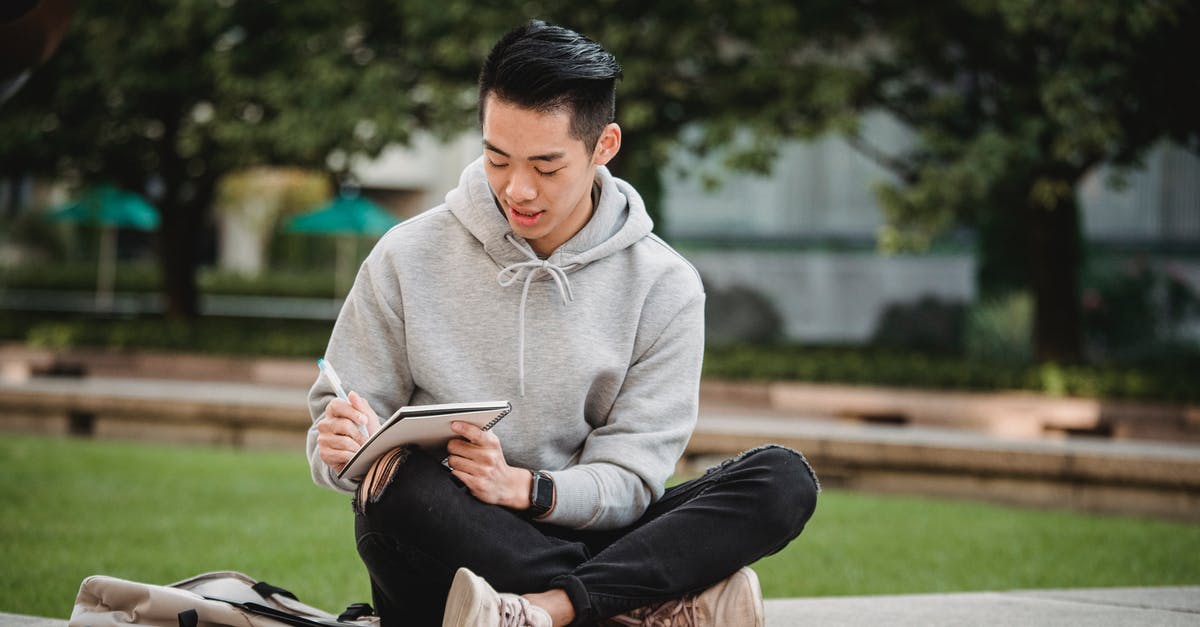 UK border crossing and electronic privacy: What do I need to know as a visitor? - Full body of concentrated Asian male in gray hoodie and ripped black jeans sitting on stone border with legs crossed and writing in notepad UK border crossing and electronic privacy: What do I need to know as a visitor? - Full body of concentrated Asian male in gray hoodie and ripped black jeans sitting on stone border with legs crossed and writing in notepad