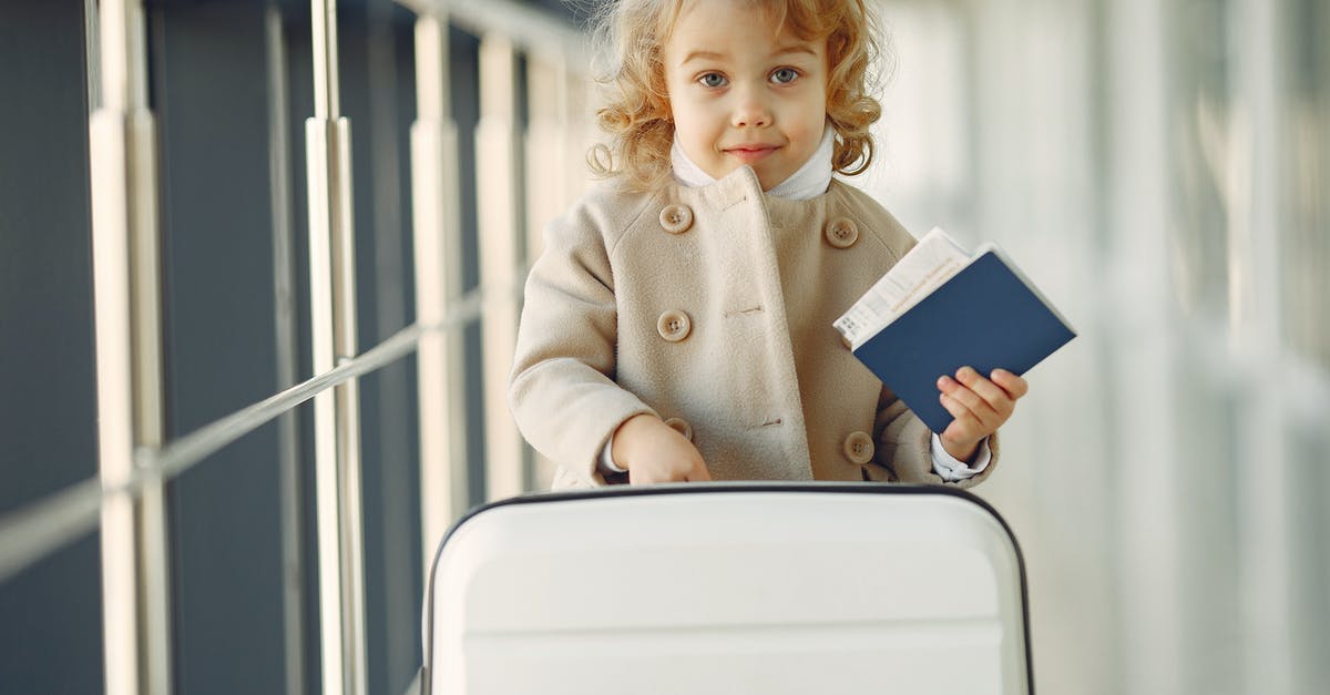 UK child travelling to Dublin on an expired passport - Cute little girl with suitcase and passport