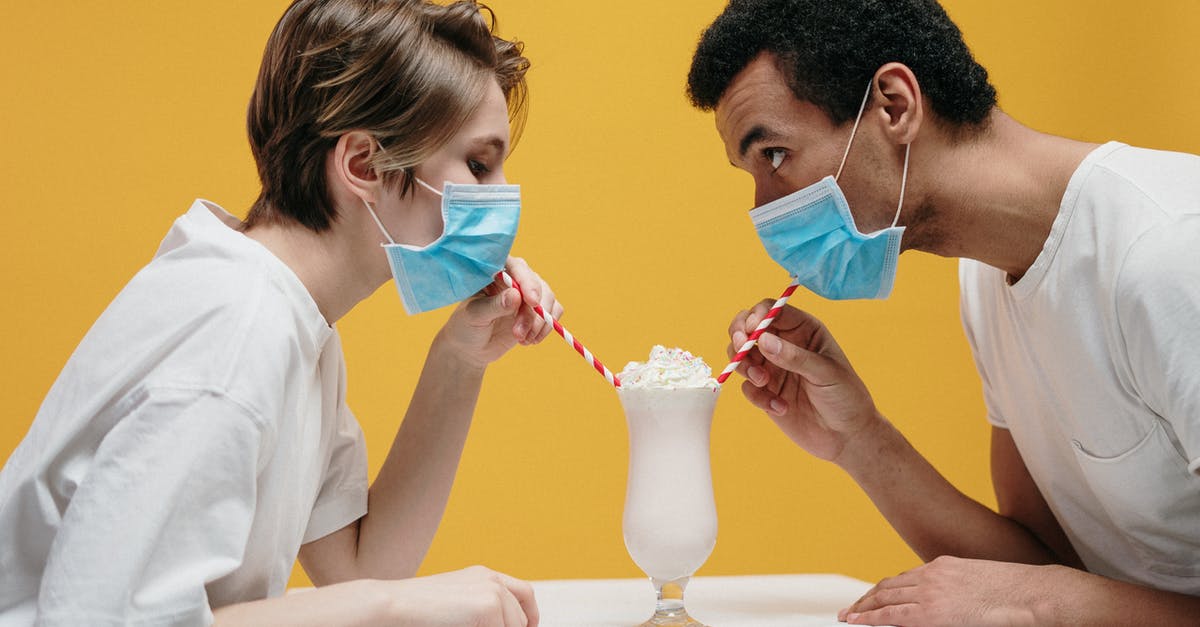 UK COVID Test-to-release programs starting date - Couple Wearing Face Mask Drinking Milkshake UK COVID Test-to-release programs starting date - Couple Wearing Face Mask Drinking Milkshake