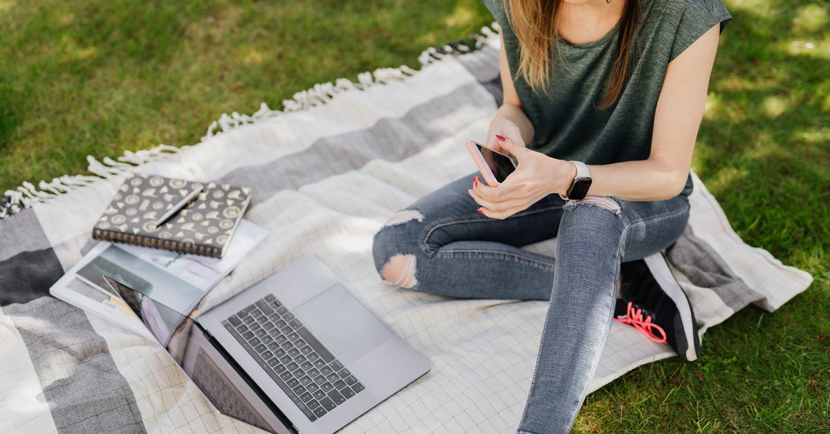 UK Immigration: Can you switch from Youth Mobility to a student visa? [closed] - From above of young crop female student in casual clothes surfing social media on smartphone while sitting with laptop and notebooks on blanket placed on green grass in sunny park
