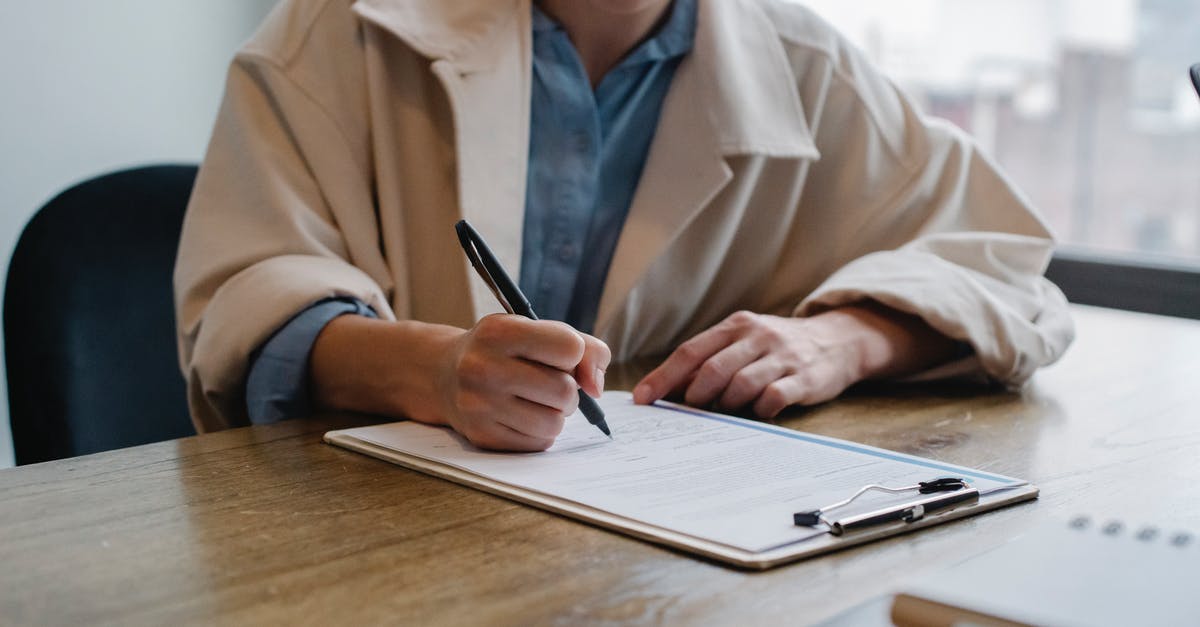 UK Immigration officers arrivals interview questions - Focused woman writing in clipboard while hiring candidate UK Immigration officers arrivals interview questions - Focused woman writing in clipboard while hiring candidate