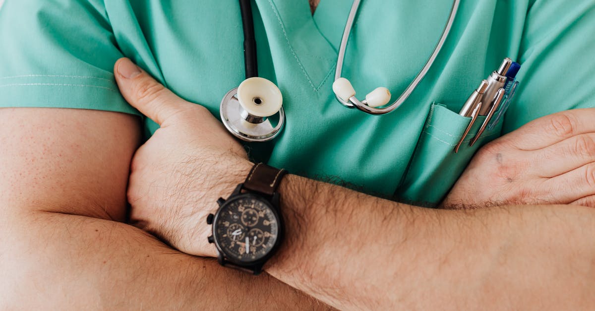 UK Passport: Emergency appointment (supporting documents) - Crop unrecognizable male doctor with stethoscope UK Passport: Emergency appointment (supporting documents) - Crop unrecognizable male doctor with stethoscope