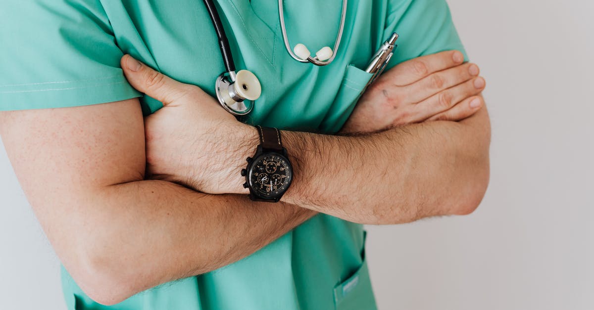 UK Passport: Emergency appointment (supporting documents) - Unrecognizable crop man in wristwatch with stethoscope UK Passport: Emergency appointment (supporting documents) - Unrecognizable crop man in wristwatch with stethoscope