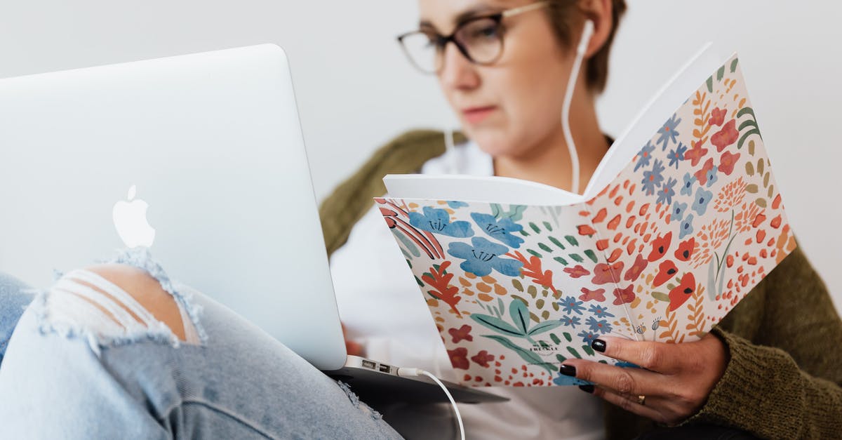 UK Student Visa Application: What defines a Media Company? - Serious woman using laptop while listening to music in earphones UK Student Visa Application: What defines a Media Company? - Serious woman using laptop while listening to music in earphones