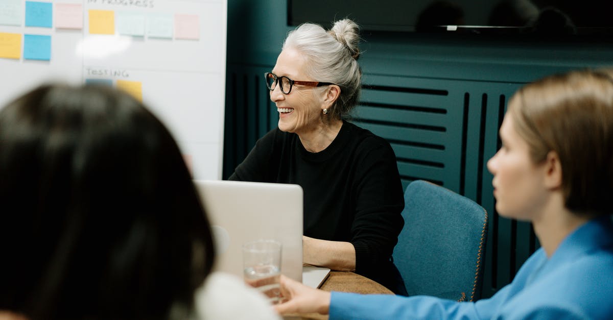 UK Visa application for conference - Self employed - Woman in Black Sweater and Eyeglasses Sitting on Chair Beside Woman in Blue Shirt UK Visa application for conference - Self employed - Woman in Black Sweater and Eyeglasses Sitting on Chair Beside Woman in Blue Shirt