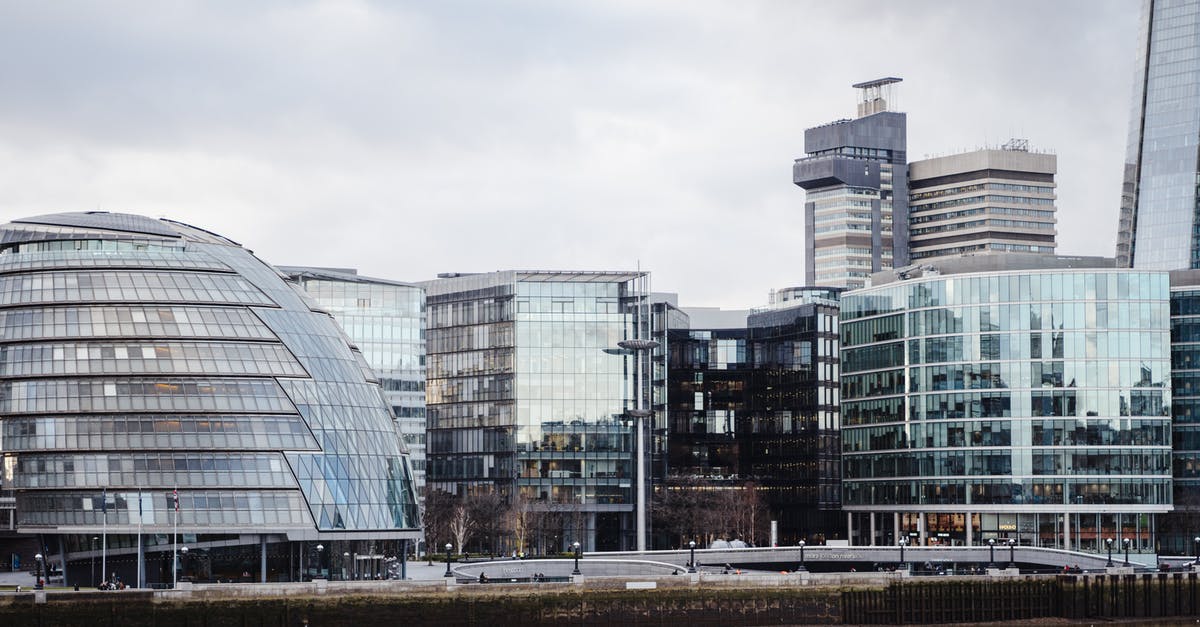 UK visa bank statement info - Contemporary buildings with glass walls located on street in financial district on embankment near calm Thames river in modern city UK visa bank statement info - Contemporary buildings with glass walls located on street in financial district on embankment near calm Thames river in modern city