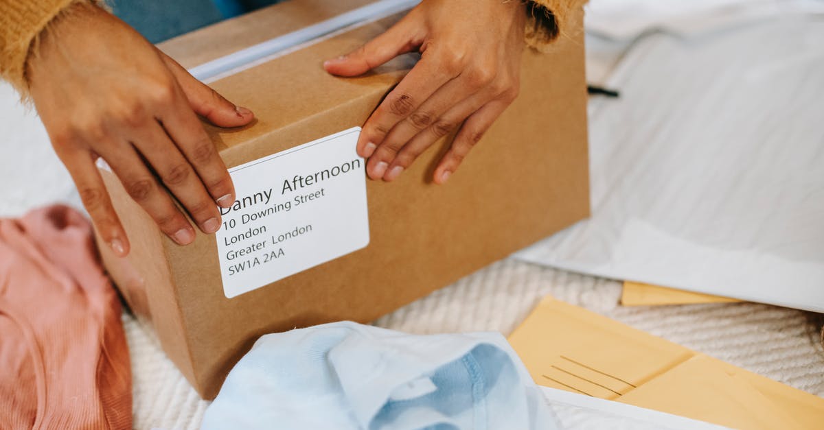 UK Visa Courier Address - Woman preparing box with parcel for sending UK Visa Courier Address - Woman preparing box with parcel for sending