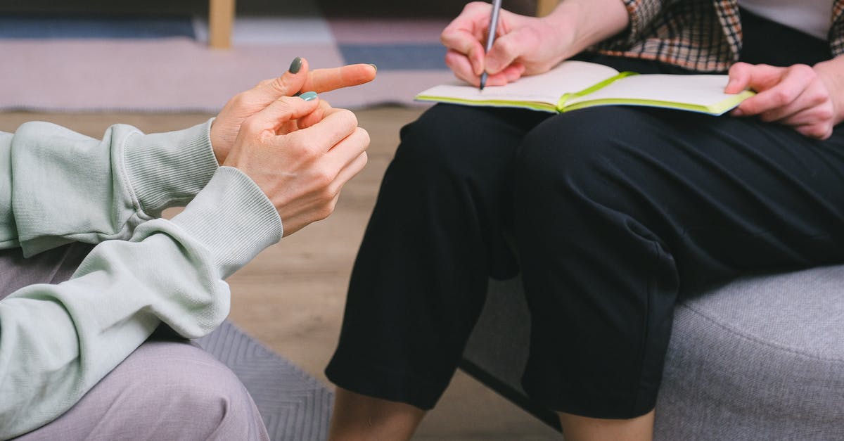 UK visa decision advice? [closed] - Anonymous female therapist and client sitting in armchairs during session in modern office