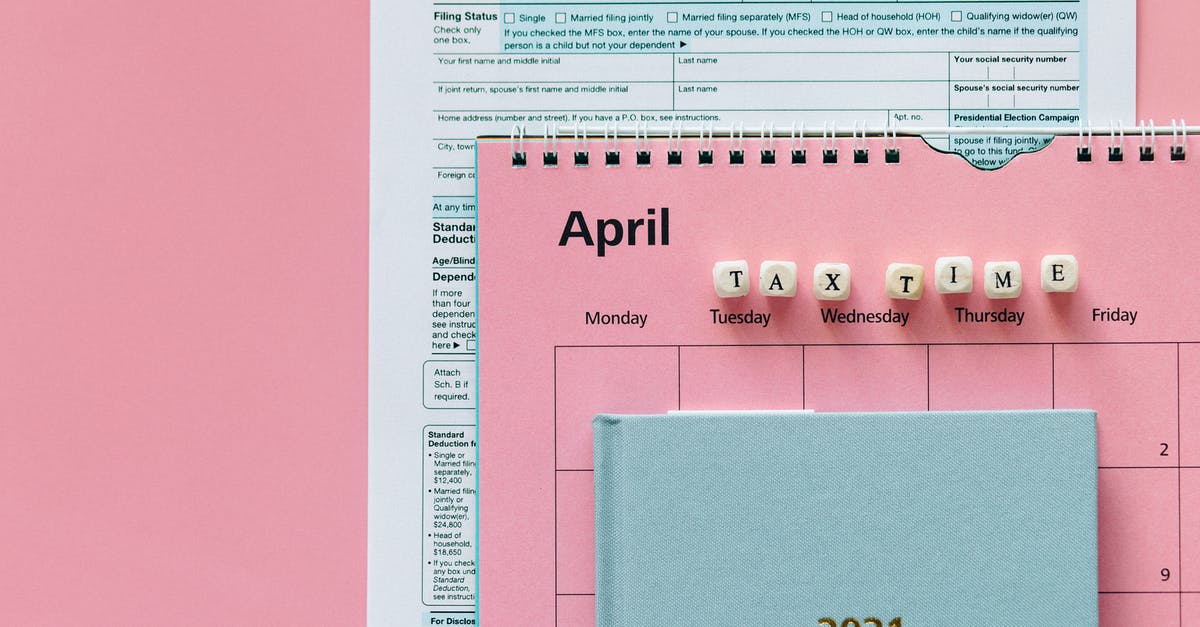 UK visa refusal due to wrong record from 9 years ago - Tax Return Form and 2021 Planner on Pink Surface