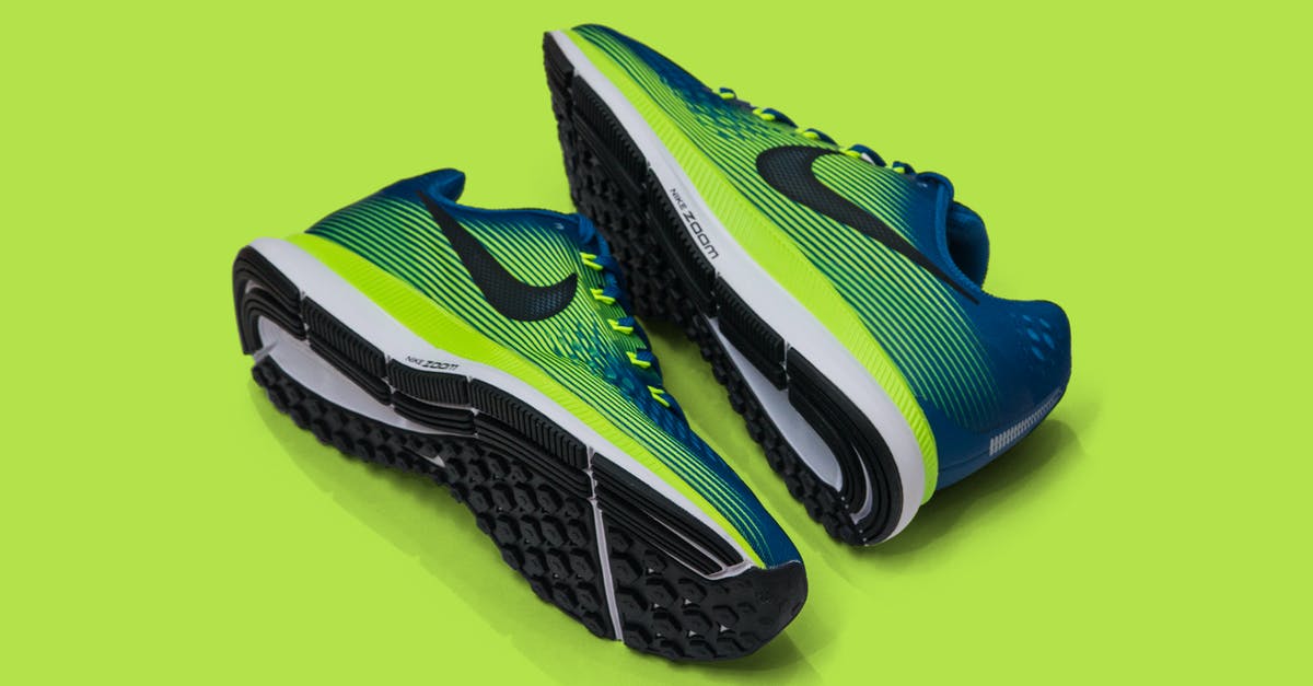 UK visa refusal, seeking temporary entry to collect personal items - From above of colored sneakers with blue and green surface and green and white and black sole for comfortable moving around streets against green background UK visa refusal, seeking temporary entry to collect personal items - From above of colored sneakers with blue and green surface and green and white and black sole for comfortable moving around streets against green background