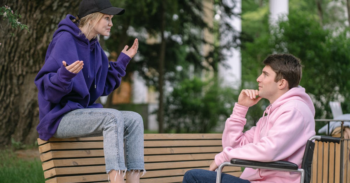 UK visa validity begins on date of issue or intended date of arrival? - Man in Purple Jacket and Blue Denim Jeans Sitting on Brown Wooden Bench