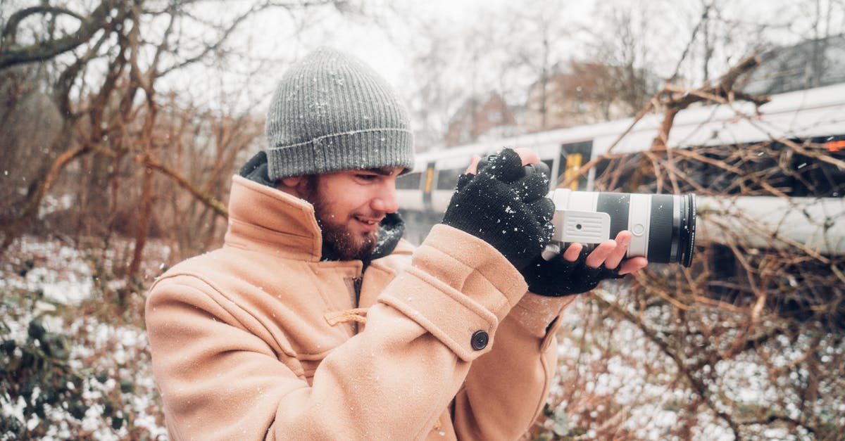 UK visit visa for an infant - how to apply if parents already hold a UK visa? - Man in Brown Coat Holding Camera